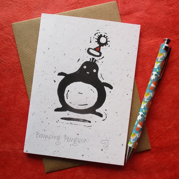 Bouncing Penguin - lino cut print Christmas card