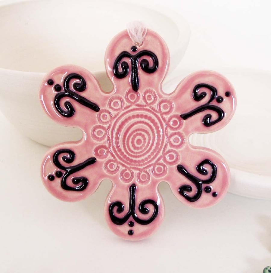 Pink ceramic flower decoration.