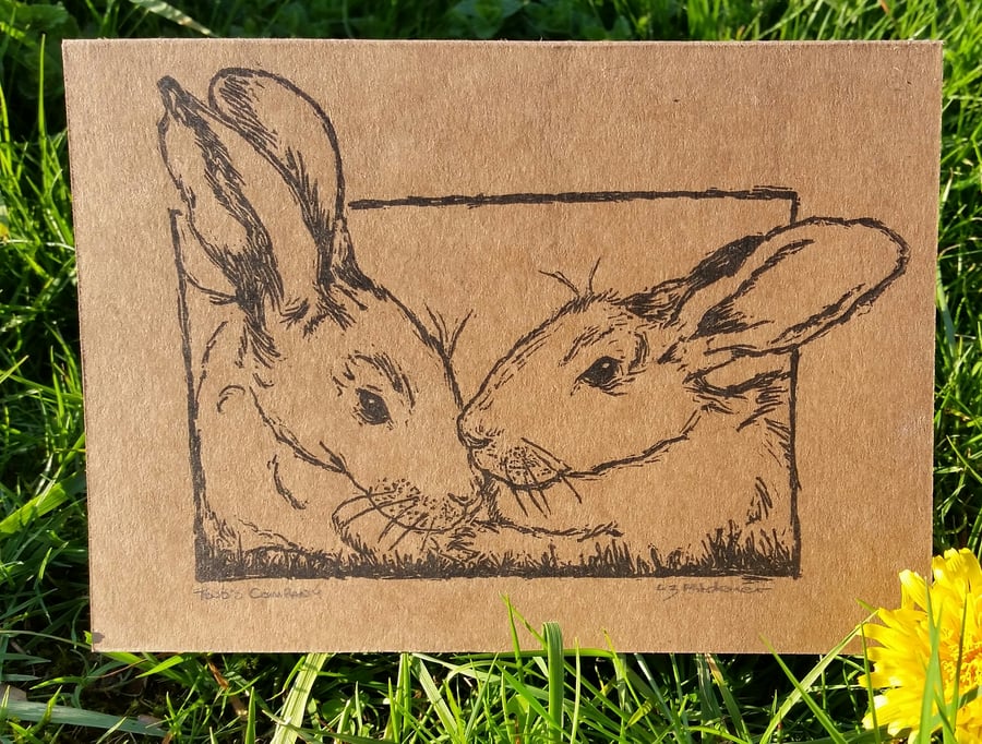 Hand printed signed linocut card "two's company" of 2 rabbits.