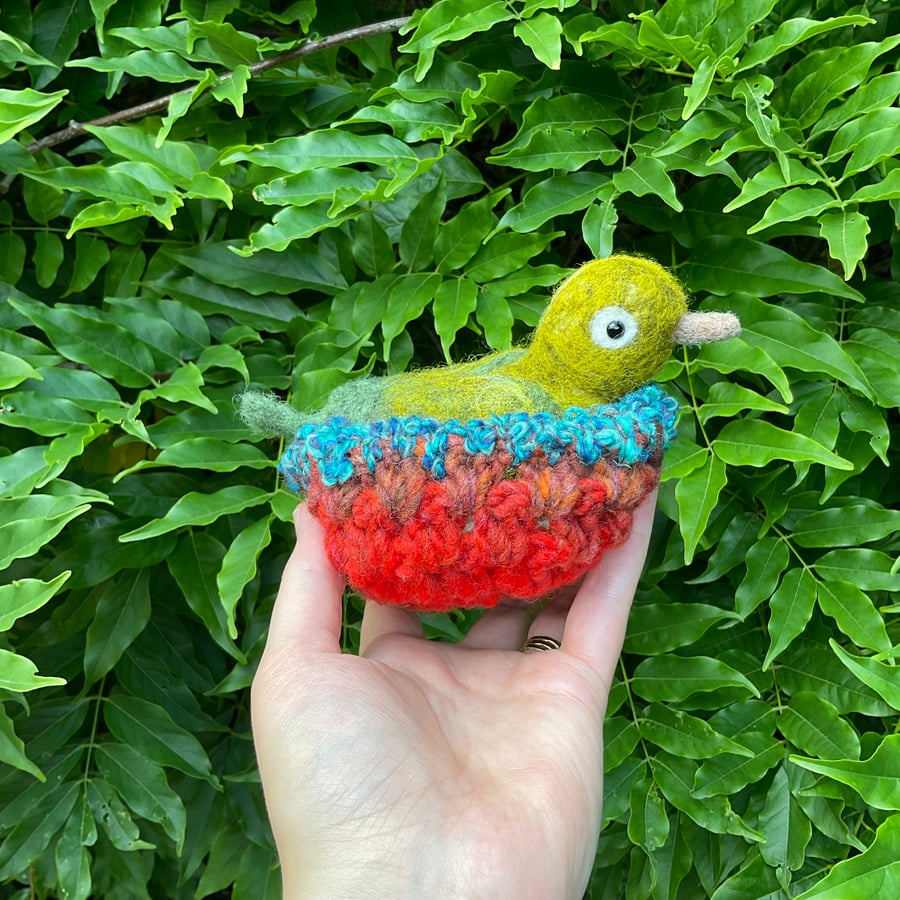 Sweet sparkly green bird in beautiful nest 