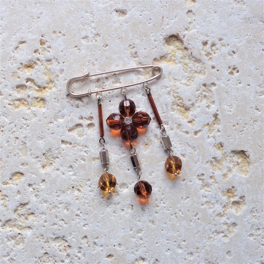 Kilt pin brooch, golden brown glass and sillver metal beads