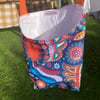 Shower-proof peg bag with orange strap. Bright ethnic design