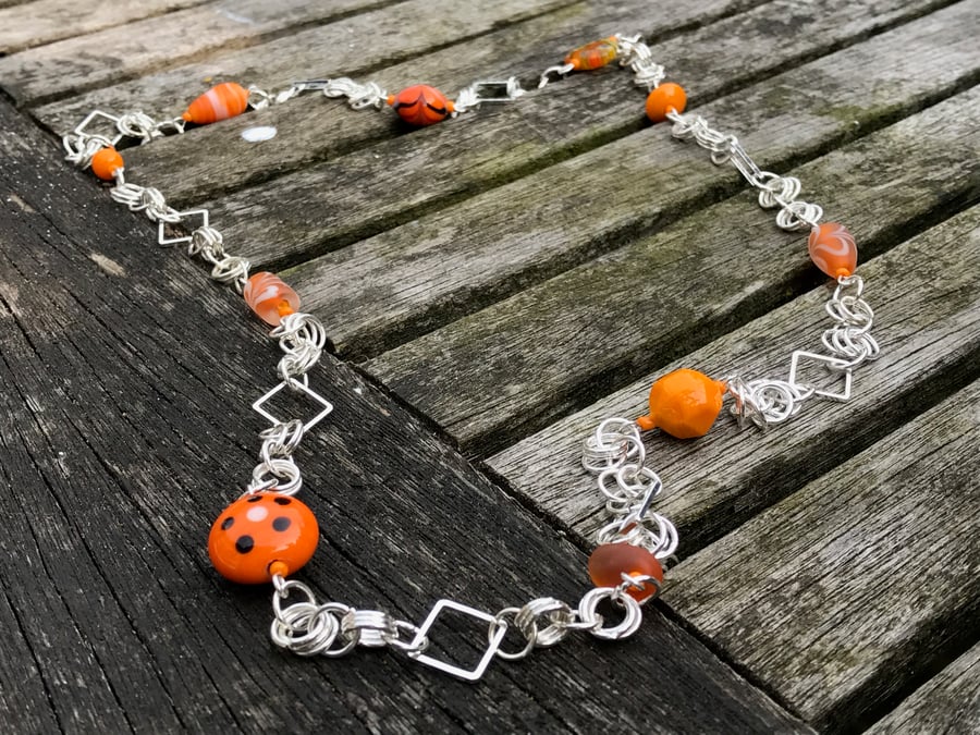 Orange glass beads and silver chainmaille long necklace