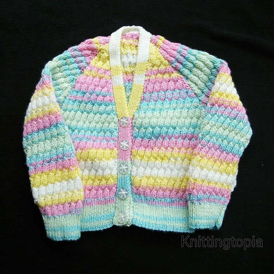 Hand knitted baby cardigan in multicoloured yarn with all over honeycomb pattern