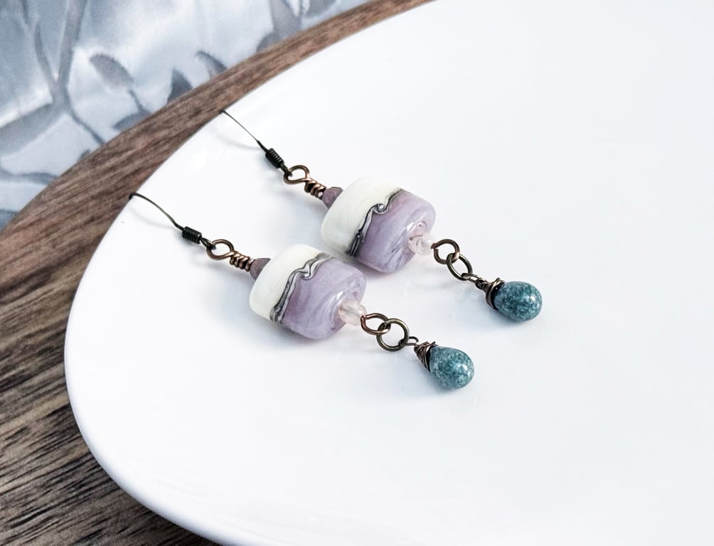Lilac and cream lampwork glass earrings with a deep green teardop