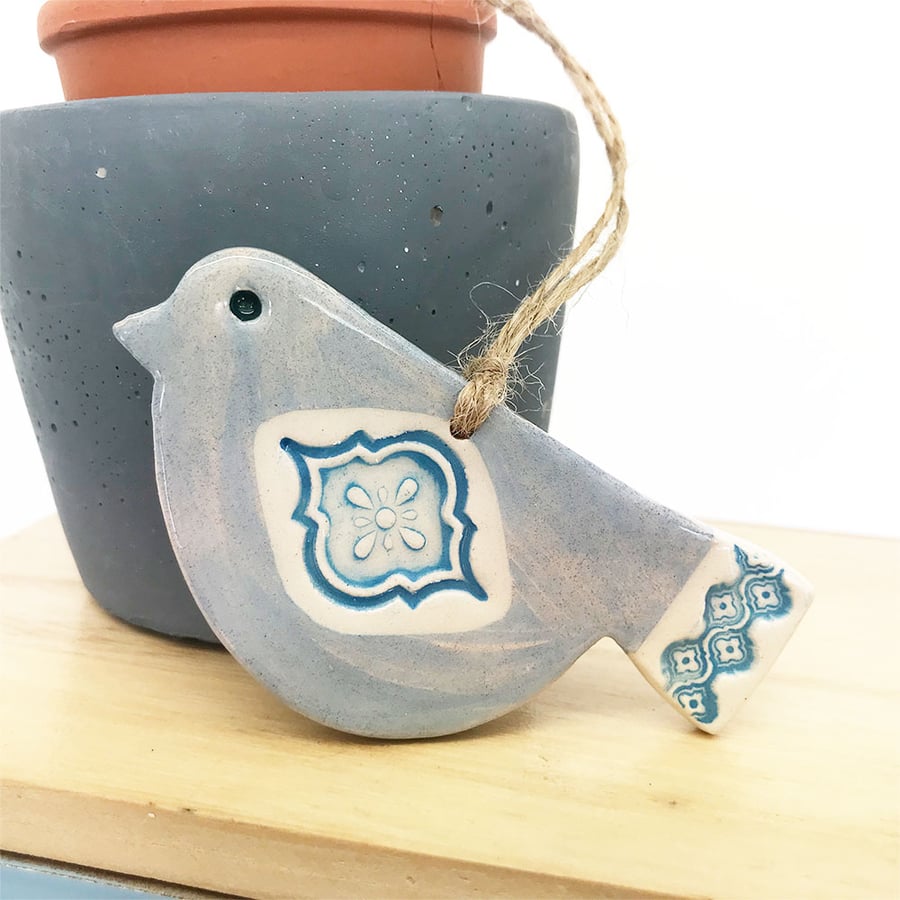 Ceramic bird decoration with patterned wing and tail 