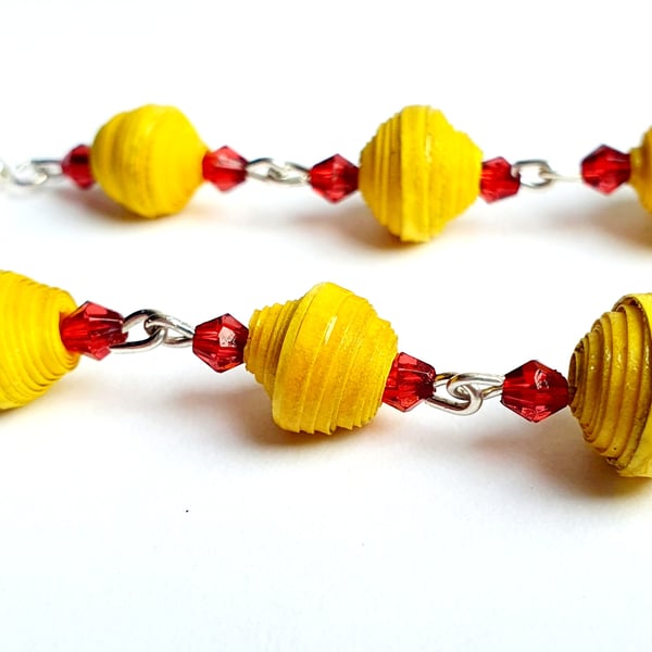 Long light earrings made with yellow paper beads