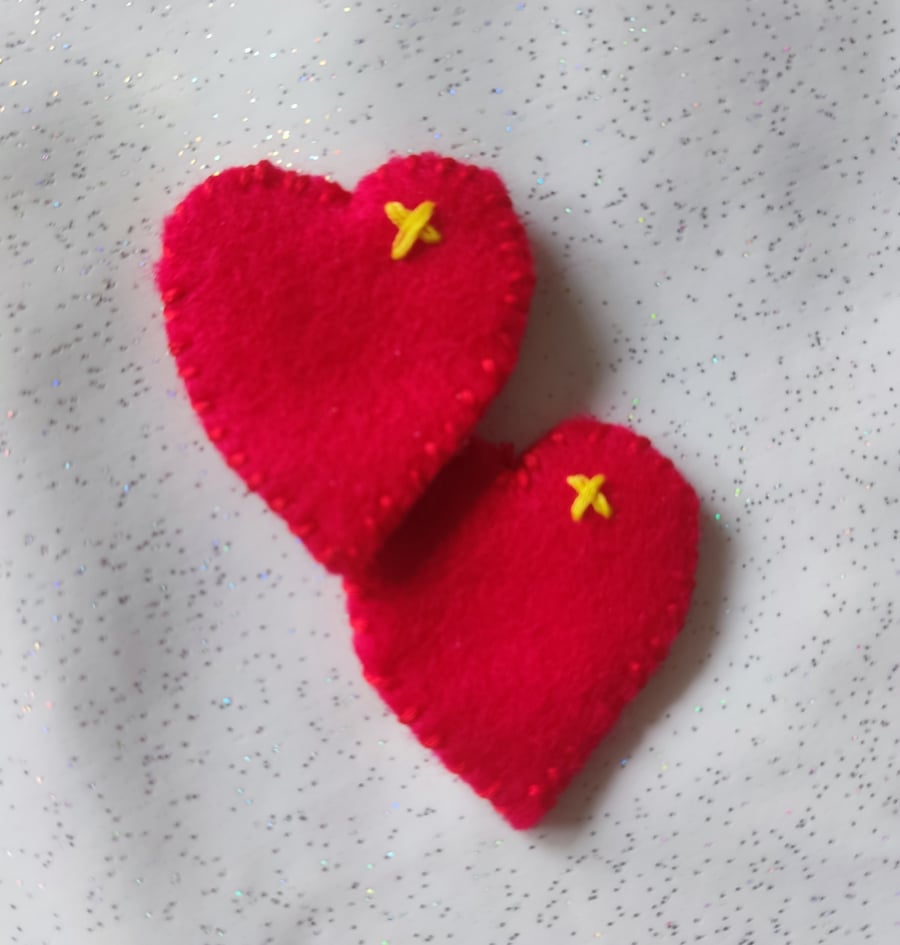 Bright red handmade felt pocket hugs, hearts
