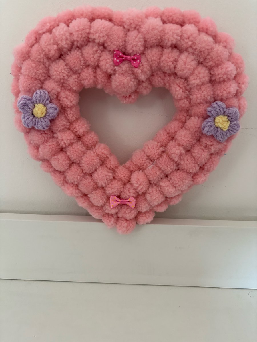 Wool Pom Pom pinks decorated wood heart wreath. 