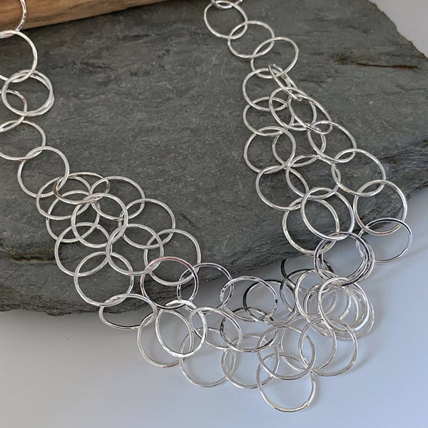 Short three layer chain necklace made from round links with a hammered finish
