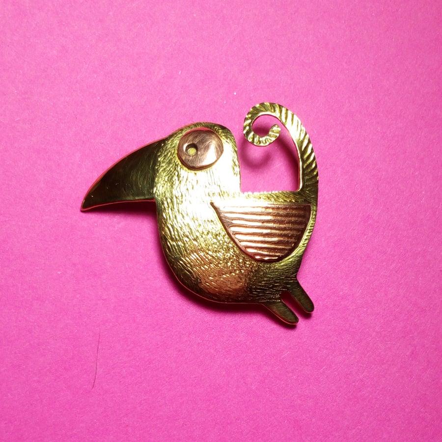 bird brooch with curly tail