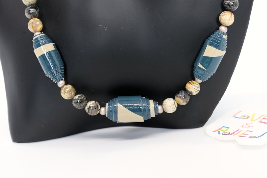Blue and beige necklace made of paper beads with earth coloured separators