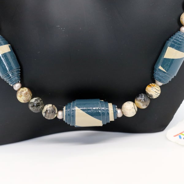 Blue and beige necklace made of paper beads with earth coloured separators