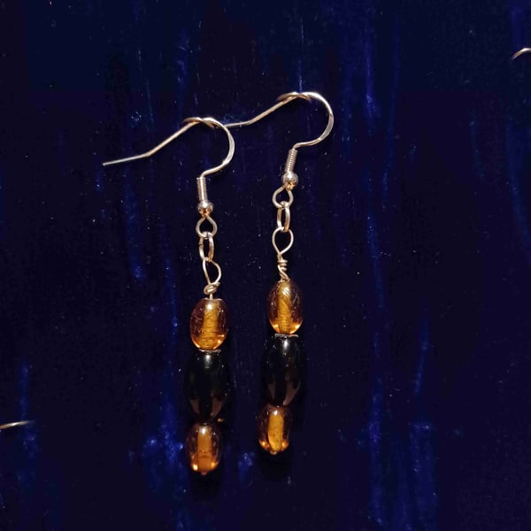 Silver earrings made with onyx and amber glass