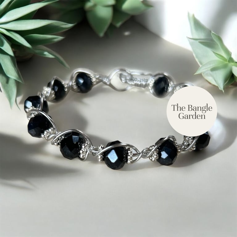 Handmade wire wrapped bangle with black faceted beads and shiny spacers