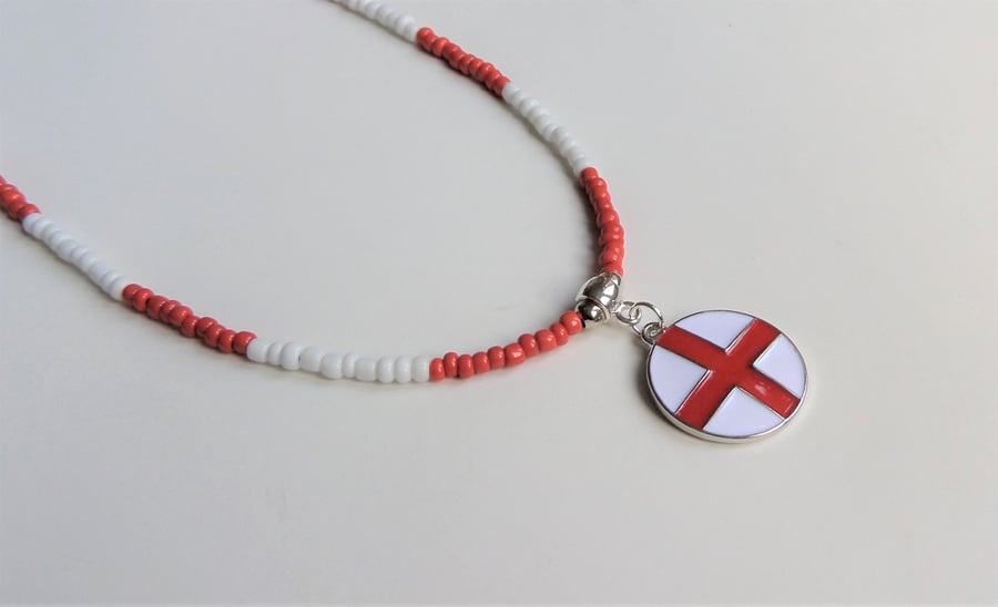 Red and white seed bead necklace, enamelled charm.