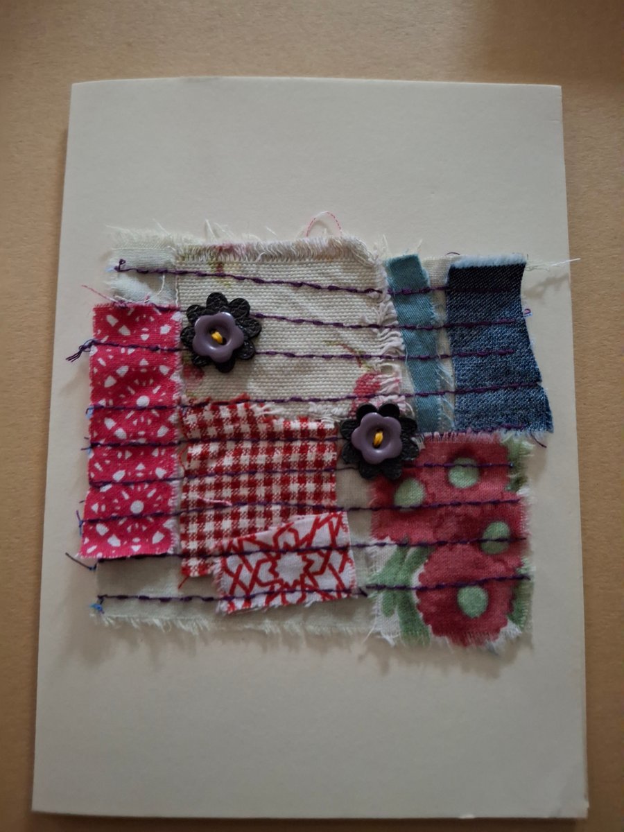 Leather flowers, flower buttons on fabric greetings card