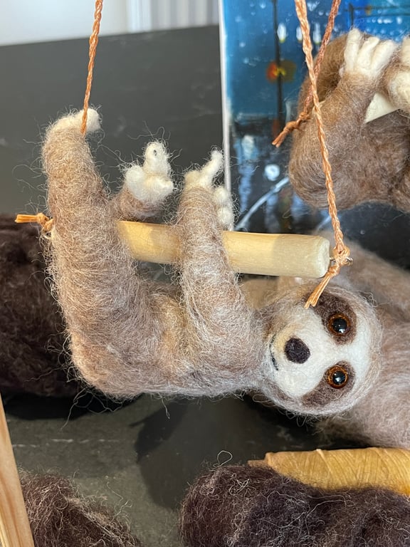 Wool felted sloth on the swing