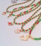 Red Gold and Green Bead Necklace with Gold Plated Enamelled Christmas Charms