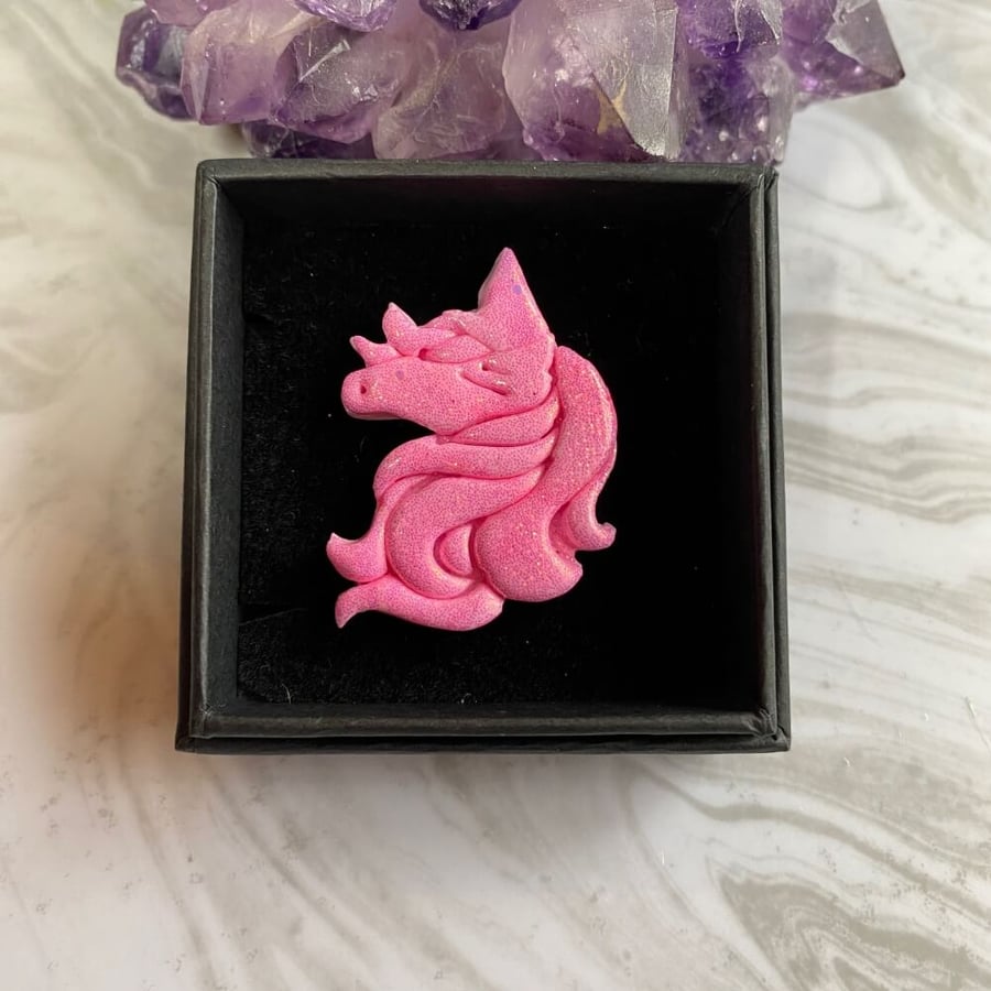 Pink glitter unicorn brooch handmade with polymer clay and resin.