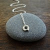 Tiny hagstone charm pendant - molten recycled silver