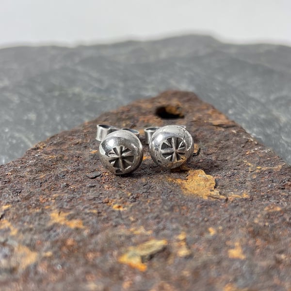 Small recycled silver stud earrings with medieval star wheel pattern