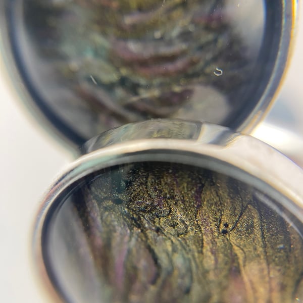 Pair of cuff links with pale purple, pinks and gold pigments 