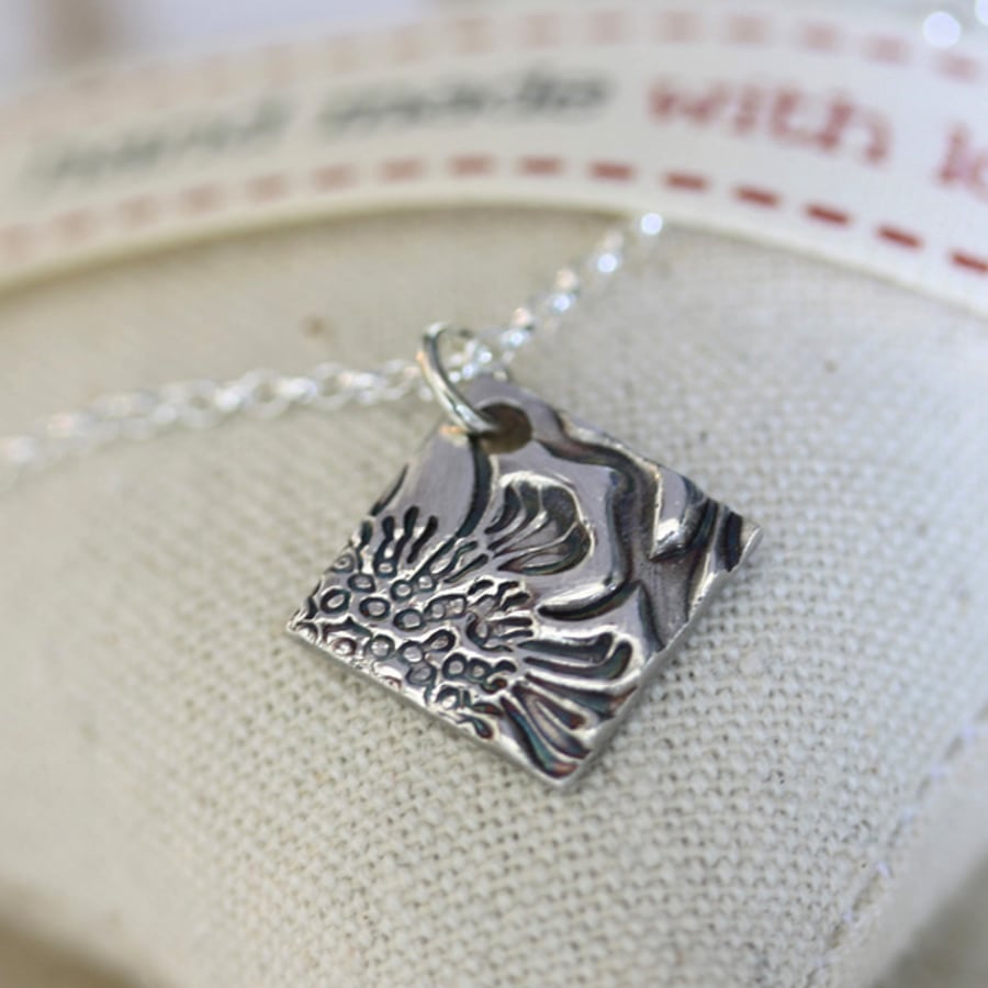 Fine silver decorative square pendant on a silver chain