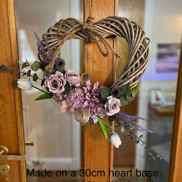 Lilac flowers on wicker heart wreath 