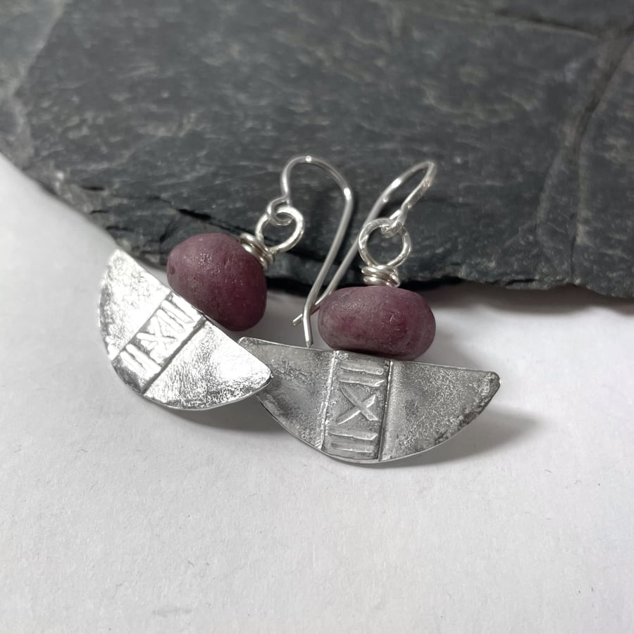Silver and ruby tribal blade earrings.