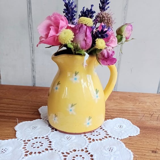 Yellow jug with white flower design
