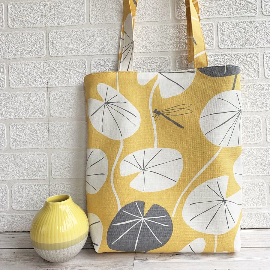 Golden yellow tote bag with lily pad leaves and dragonfly