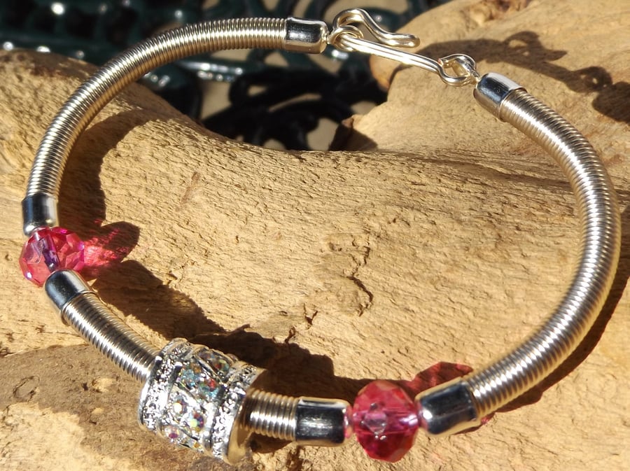 silver plated wire bracelet with pink crystals and rhinestone charm 