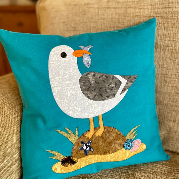 Cheeky seagull sitting on a rock appliqué cushion cover