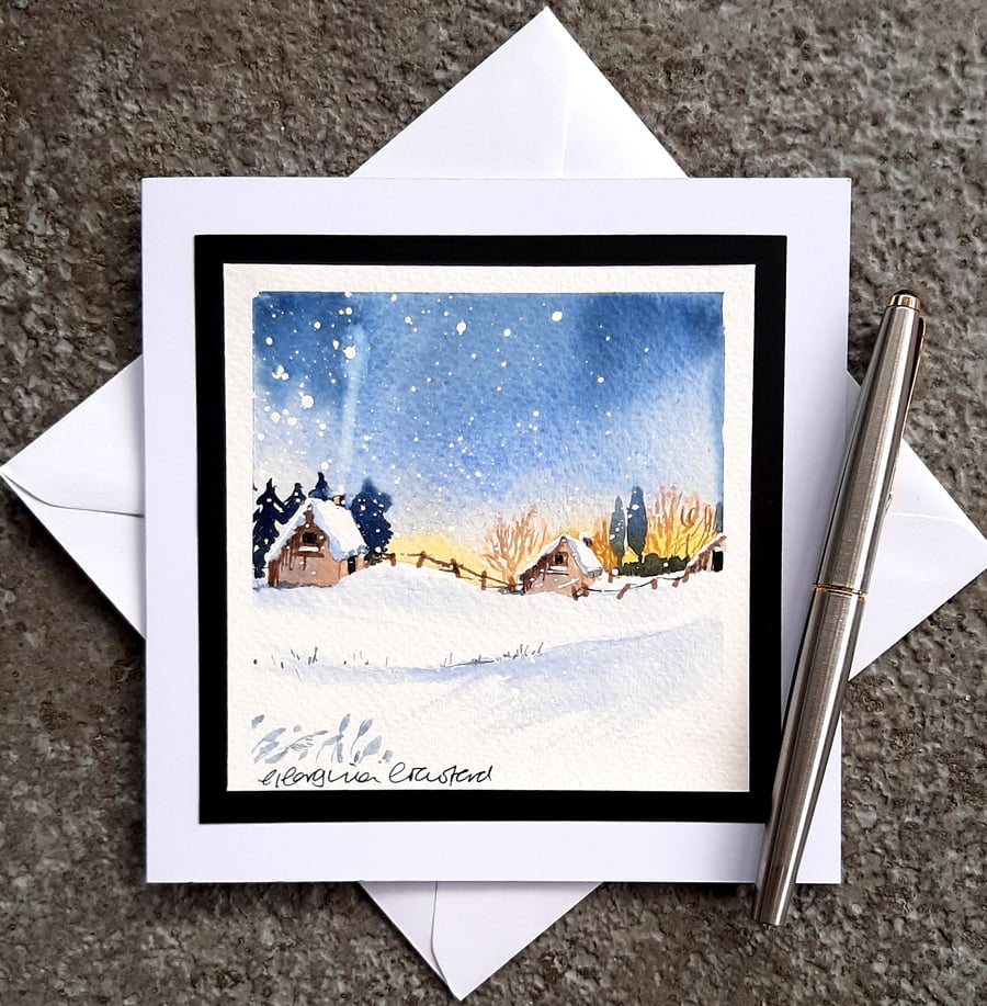 Handpainted Blank Christmas Card. Log Cabins in a Sunset Snowy Scene