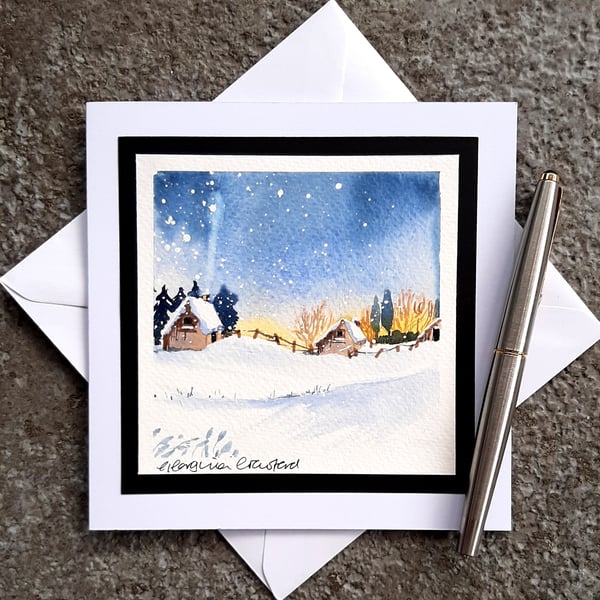 Handpainted Blank Christmas Card. Log Cabins in a Sunset Snowy Scene