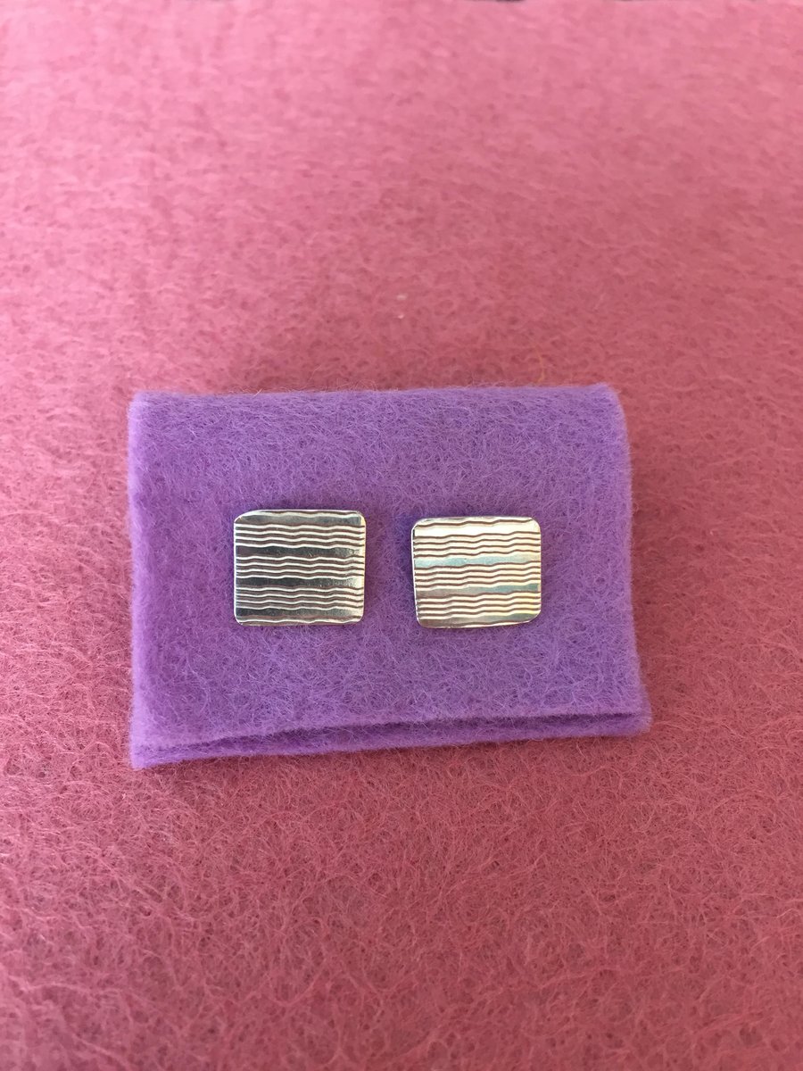 Silver stud earrings made from a cigarette case