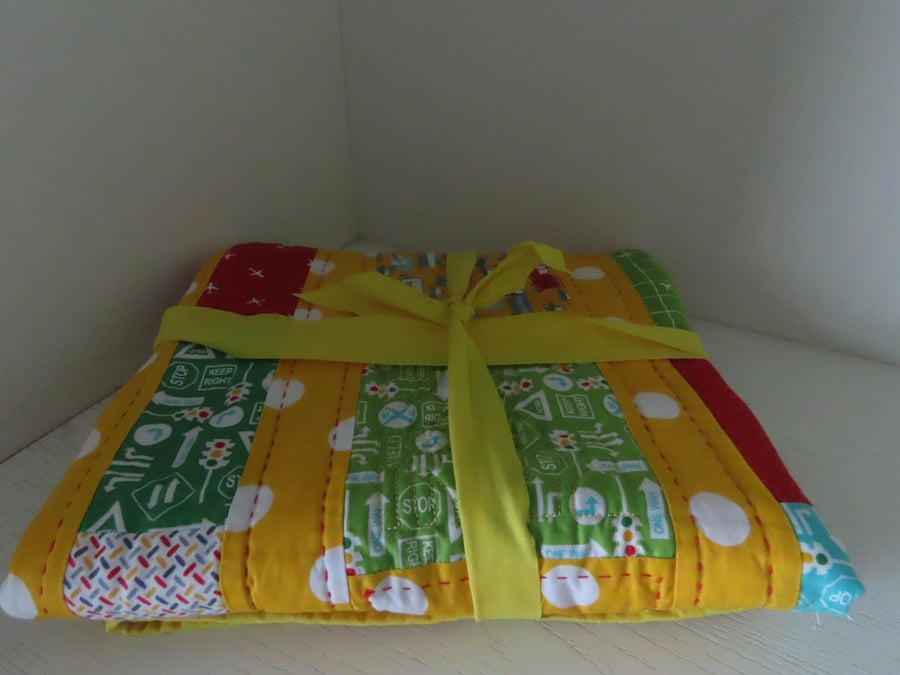 Handmade, quilted cot blanket for the nursery.