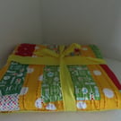 Handmade, quilted cot blanket for the nursery.