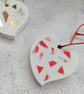 A handmade jesmonite heart filled with bright red hand dyed aluminium pieces - Image 2