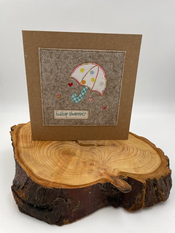 Baby shower card with appliqué umbrella and embroidered hearts