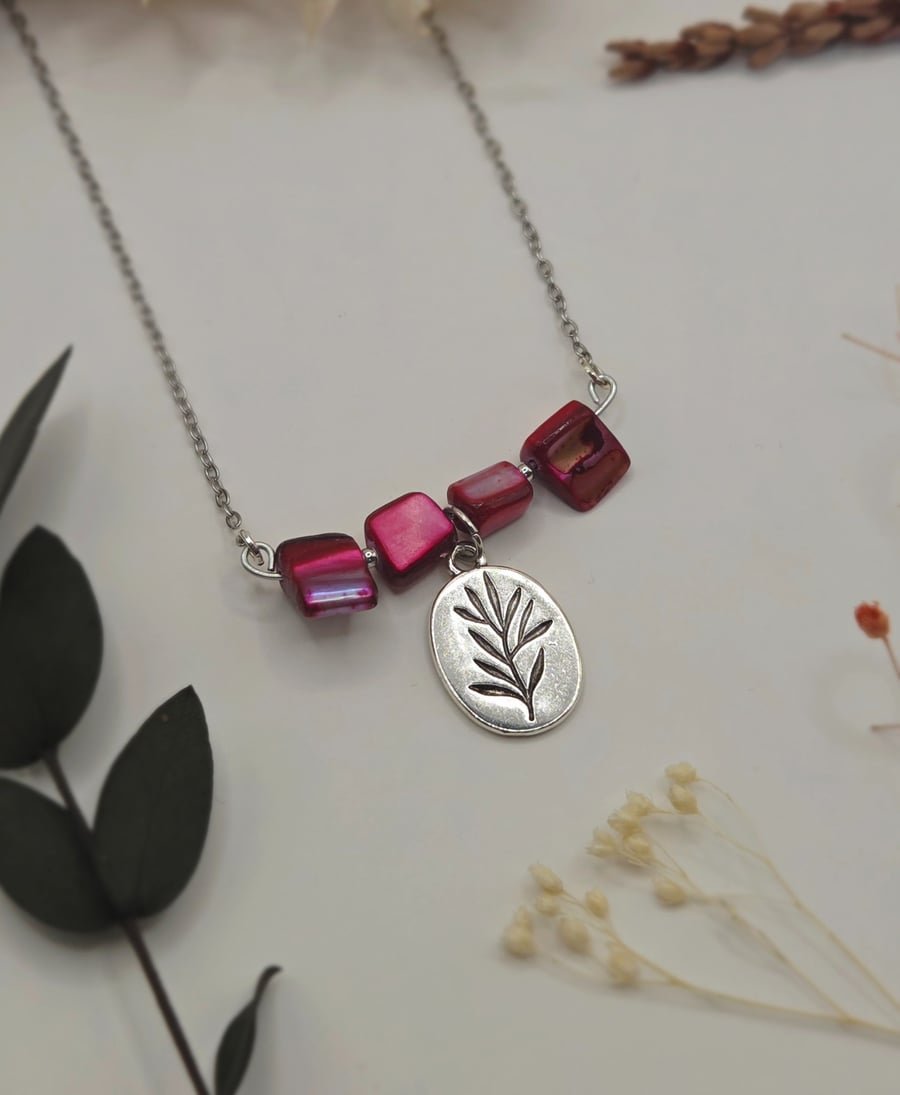 Pink mother of pearl beaded necklace with silver floral charm