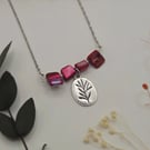 Pink mother of pearl beaded necklace with silver floral charm