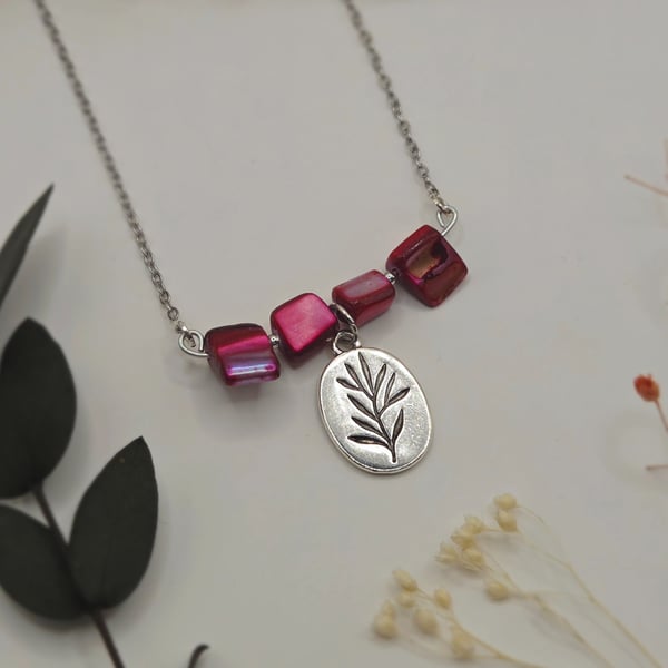 Pink mother of pearl beaded necklace with silver floral charm