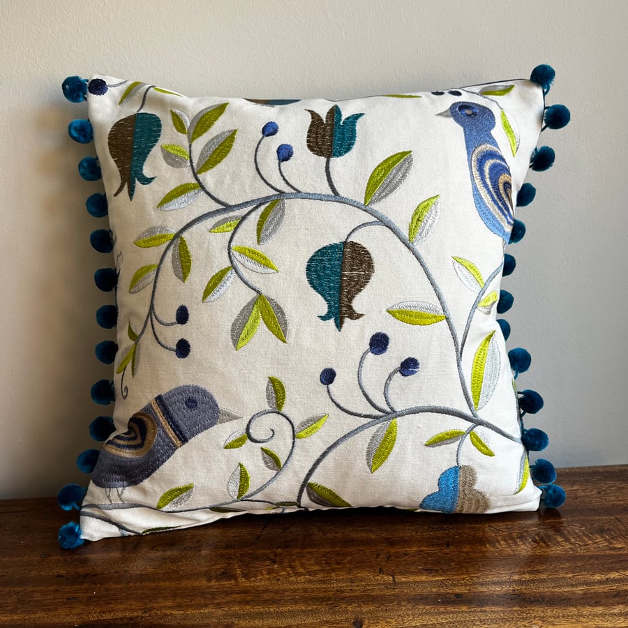 Bird cushion cover with embroidery and pompoms and reclaimed denim back