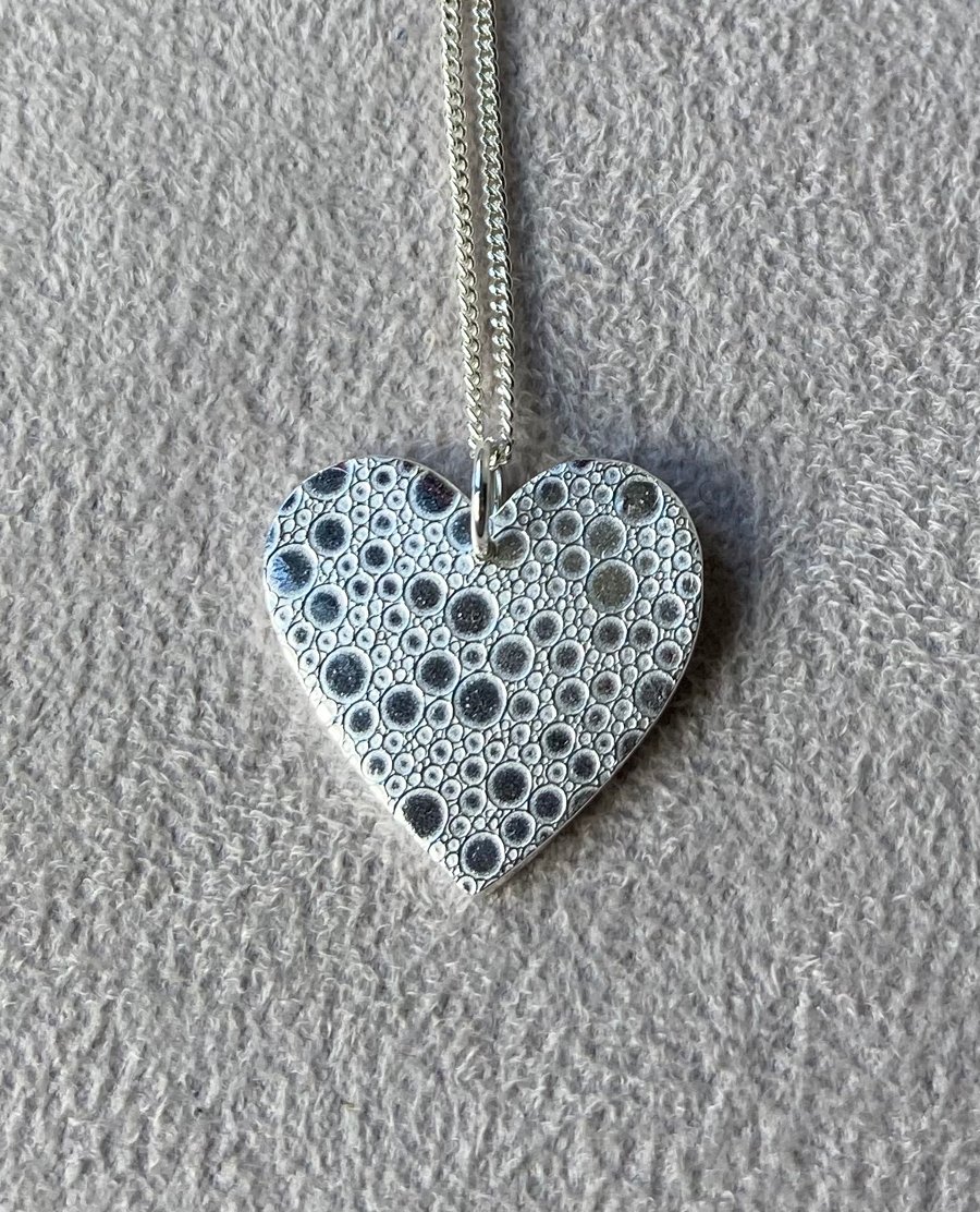 Pretty, pure silver heart with bubble pattern. 
