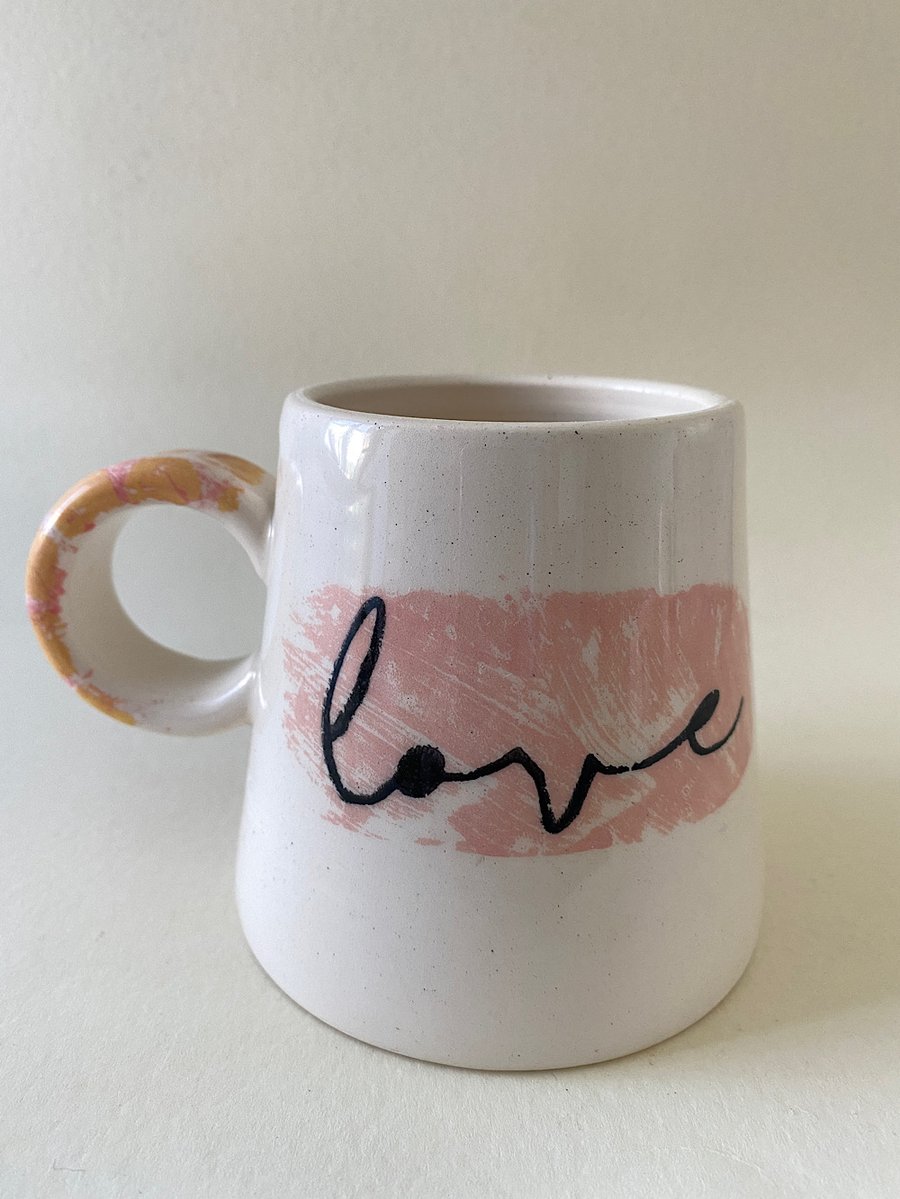 Yellow spot handle ceramic love mug.