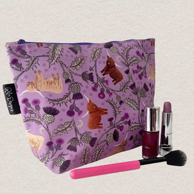 Makeup bags highland cows and silver thistles.