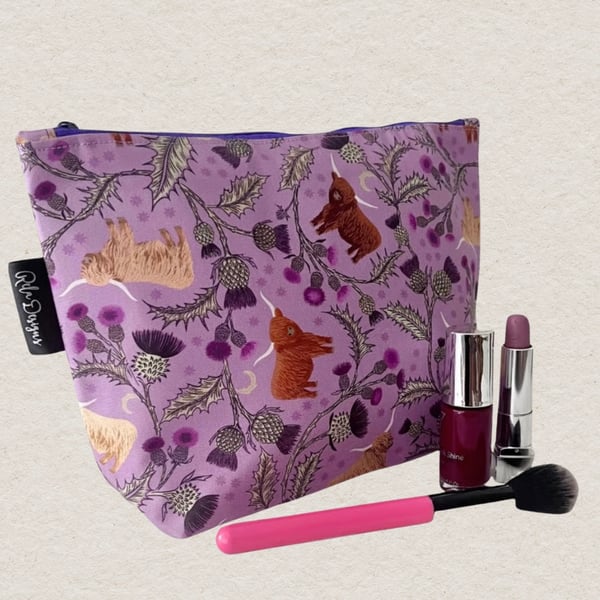 Makeup bags highland cows and silver thistles.