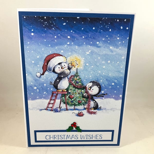 Christmas card - penguins decorating tree